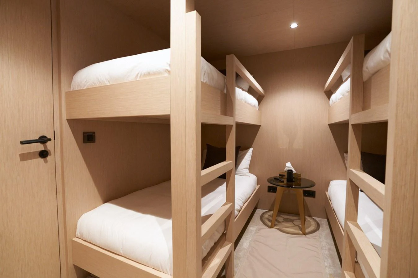 a bed with a white sheet aboard MANGUSTA 108 Yacht for Sale