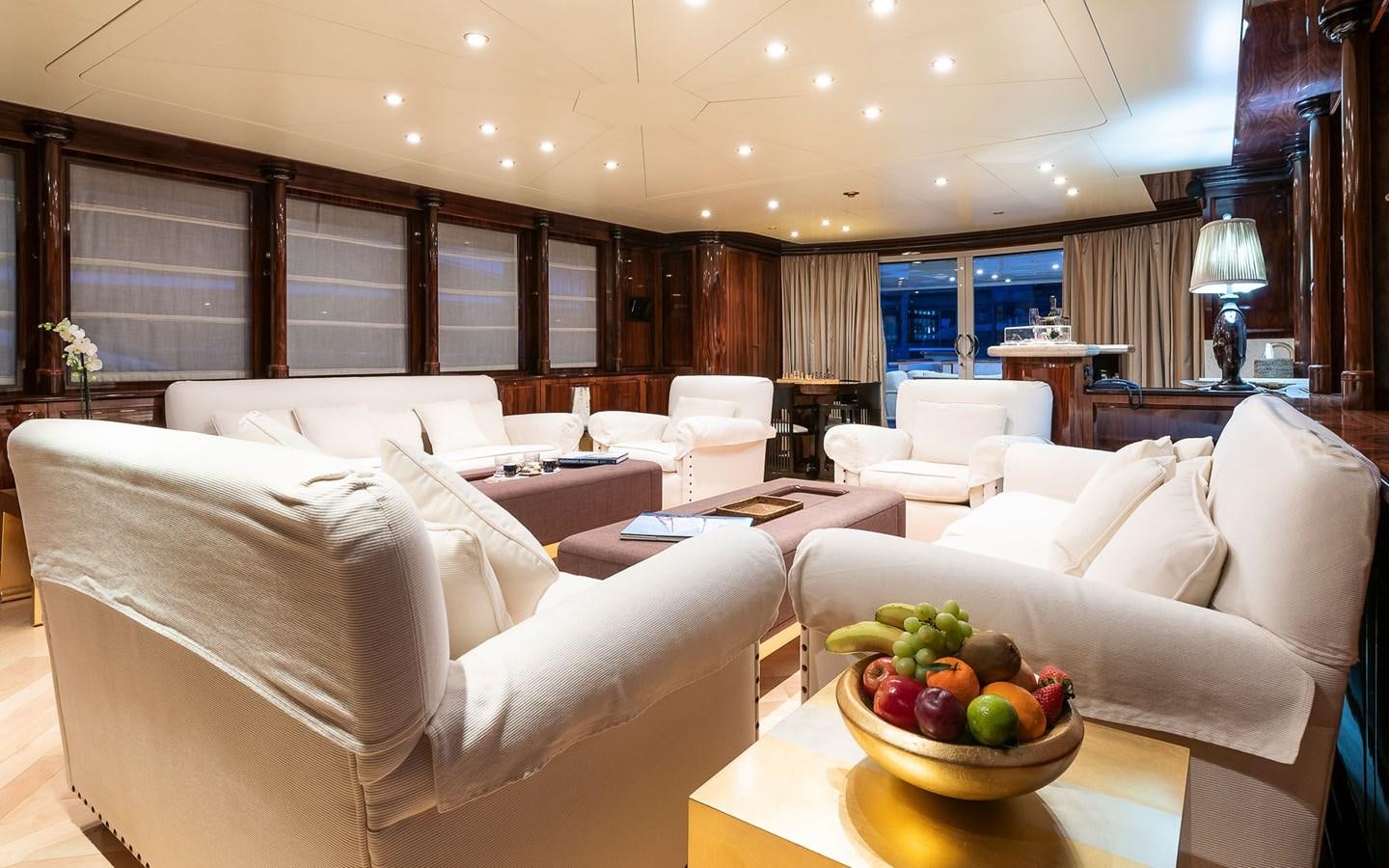 a room with a couch and a table with fruit on it aboard BLUE MAGIC Yacht for Sale