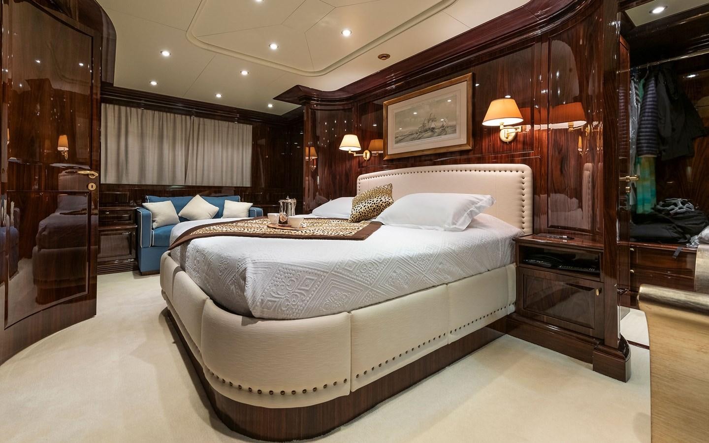 a room with a bed and a chair aboard BLUE MAGIC Yacht for Sale