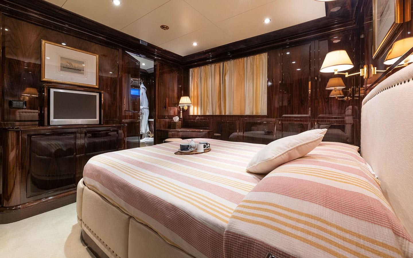 a hotel room with a bed and a television aboard BLUE MAGIC Yacht for Sale