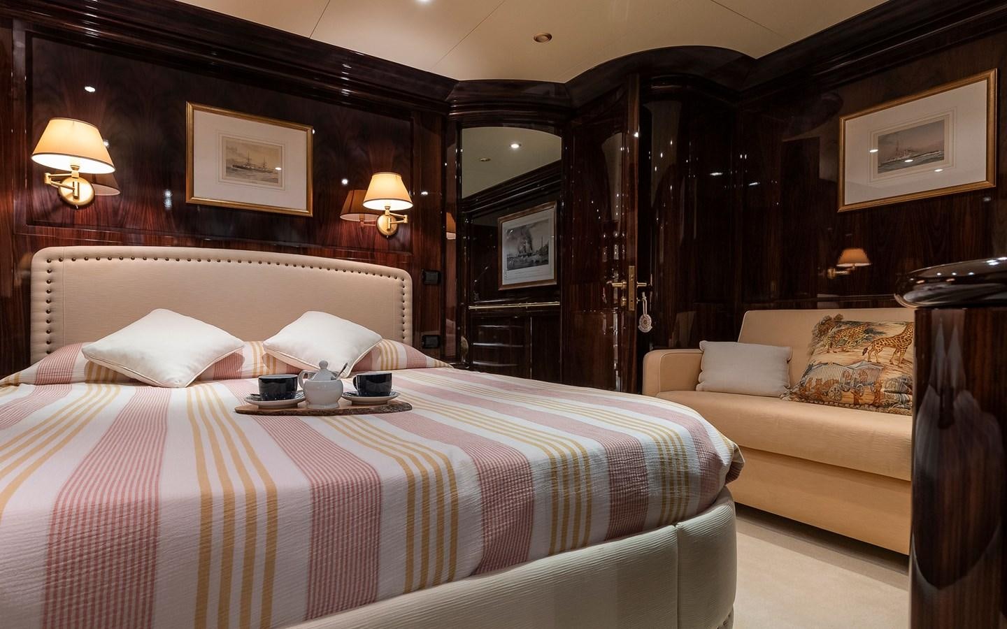 a hotel room with a bed and a couch aboard BLUE MAGIC Yacht for Sale