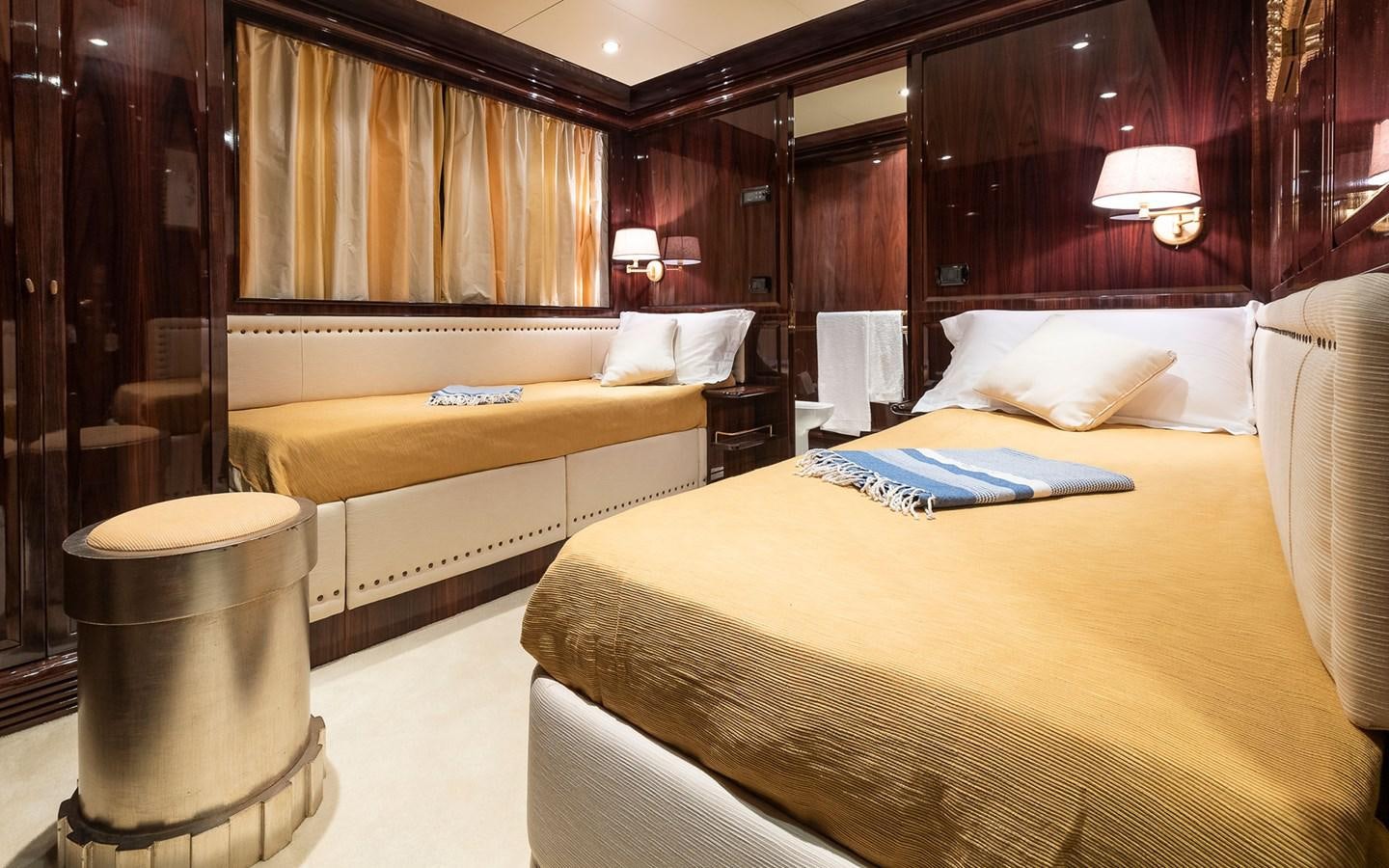 a room with a bed and a table aboard BLUE MAGIC Yacht for Sale