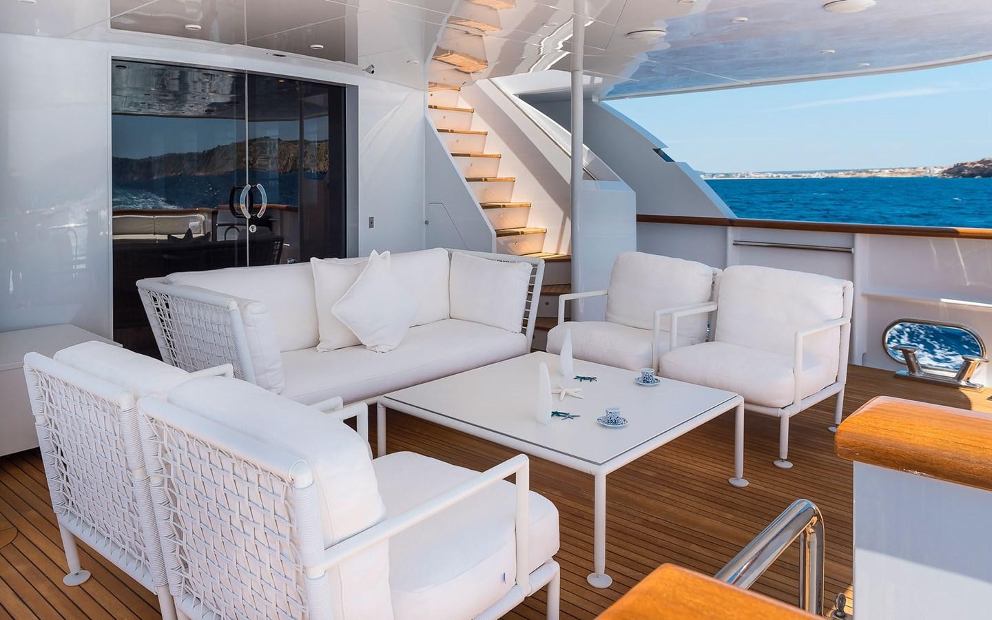 a room with a table chairs and a large window aboard BLUE MAGIC Yacht for Sale