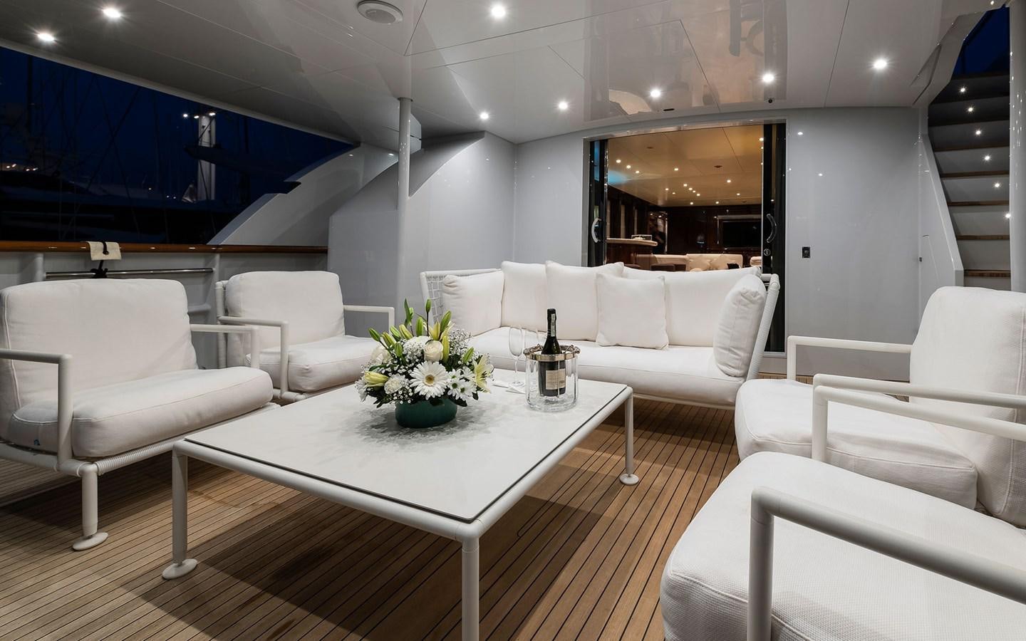 a room with white furniture aboard BLUE MAGIC Yacht for Sale