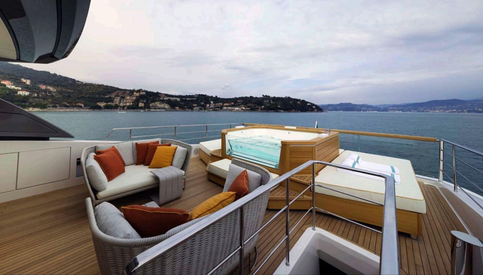 a balcony with a view of the ocean and mountains in the background aboard SALT Yacht for Charter