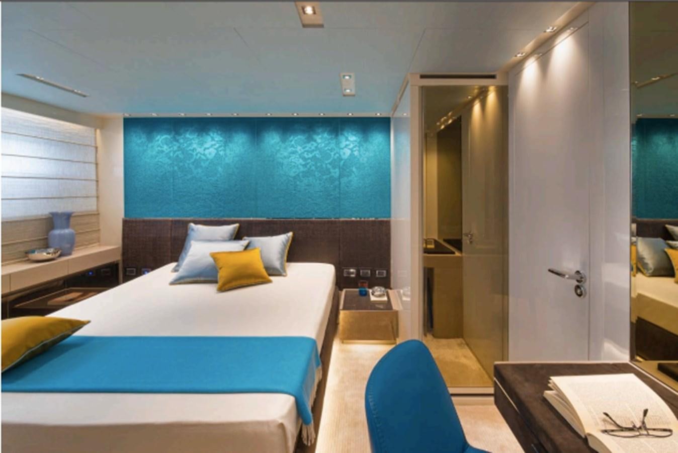 a room with a bed and a desk aboard SALT Yacht for Charter