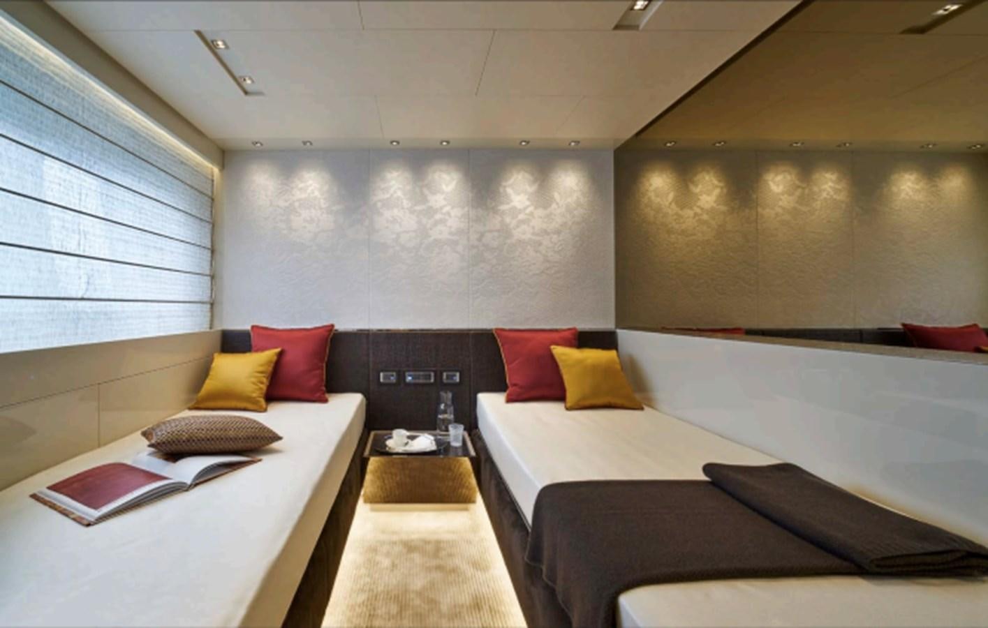 a room with a bed and a desk aboard SALT Yacht for Charter