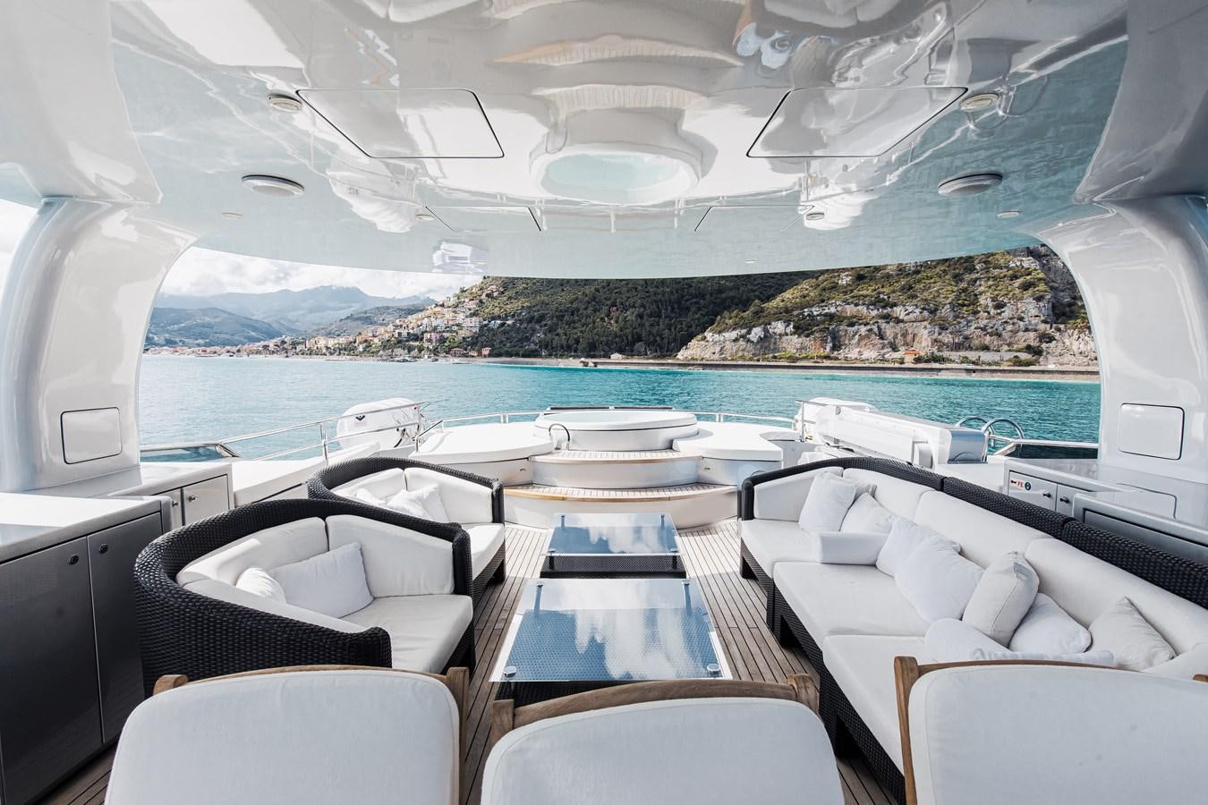 a room with a pool and lounge chairs aboard XO OF THE SEAS Yacht for Sale