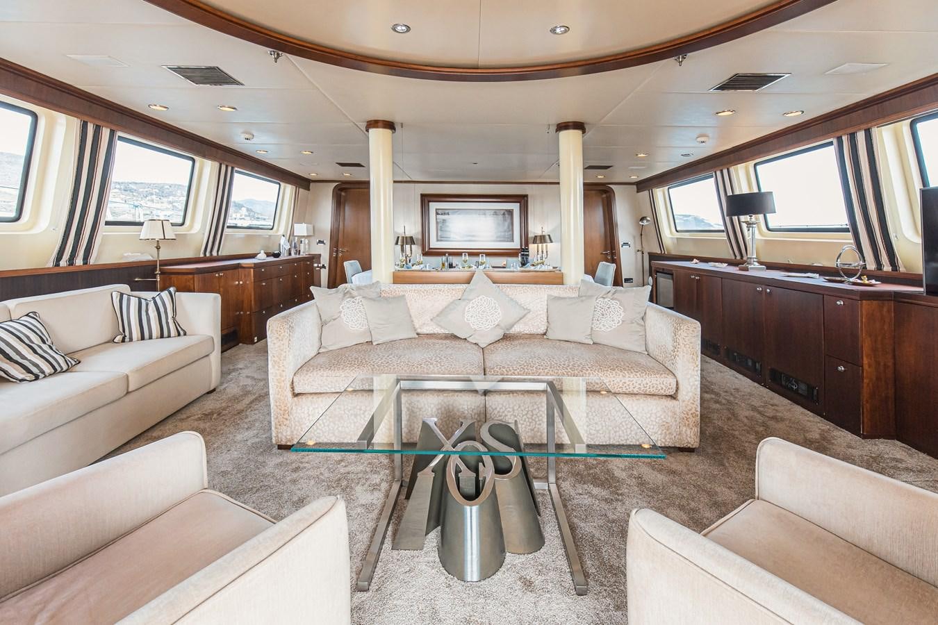 a living room with a couch and a table aboard XO OF THE SEAS Yacht for Sale