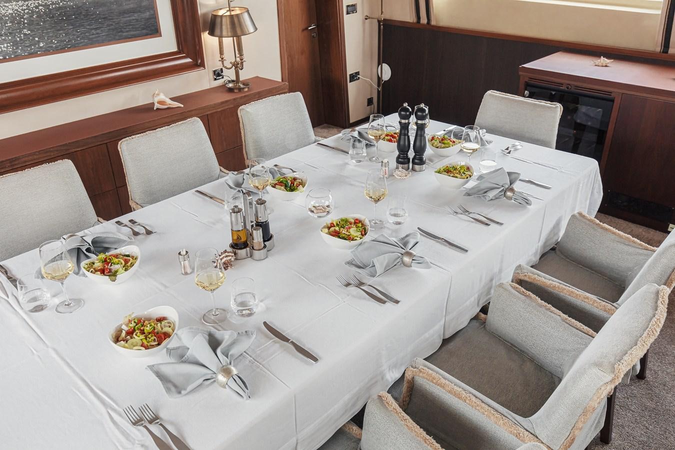 a table set for a dinner aboard XO OF THE SEAS Yacht for Sale