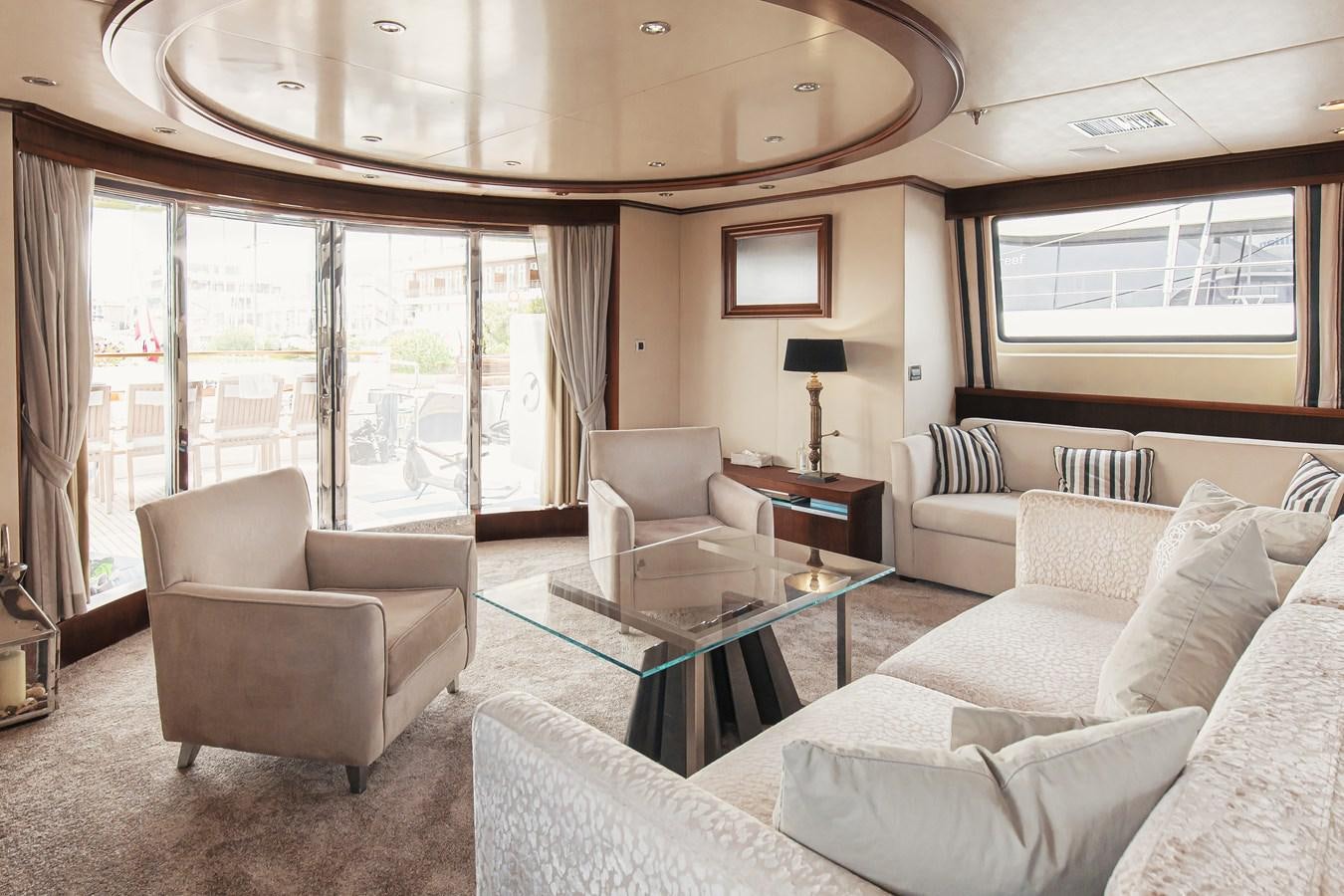 a living room with a large window aboard XO OF THE SEAS Yacht for Sale