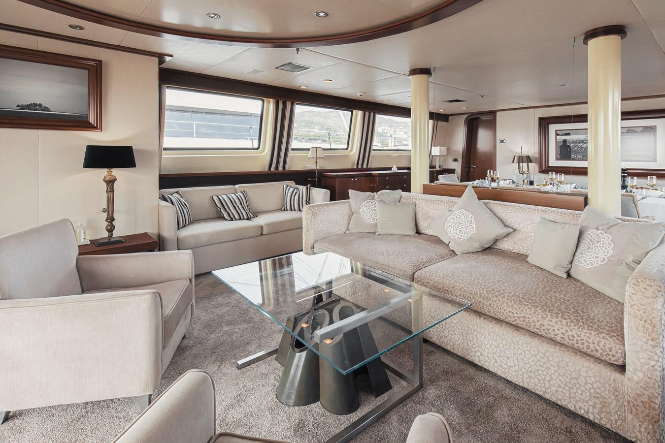a living room with a large window aboard XO OF THE SEAS Yacht for Sale