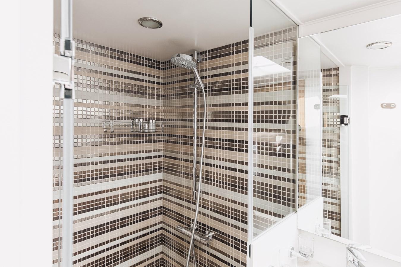 a shower unit with a glass door aboard XO OF THE SEAS Yacht for Sale