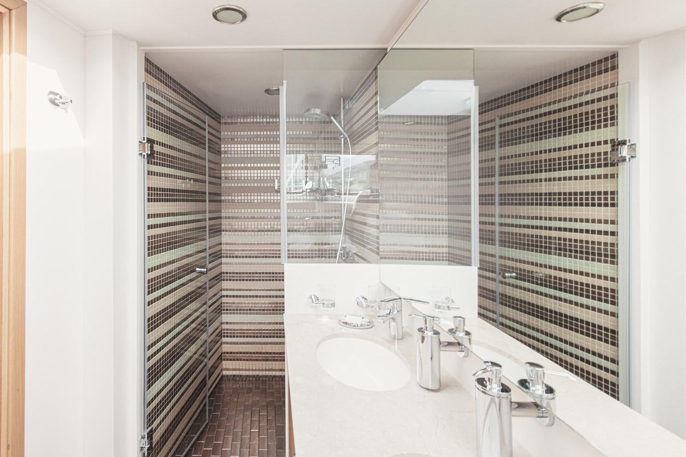 a bathroom with a sink and a shower aboard XO OF THE SEAS Yacht for Sale