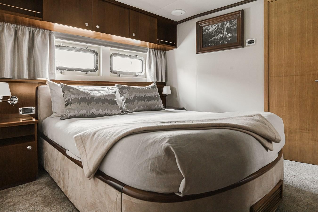 a bed with a white sheet aboard XO OF THE SEAS Yacht for Sale