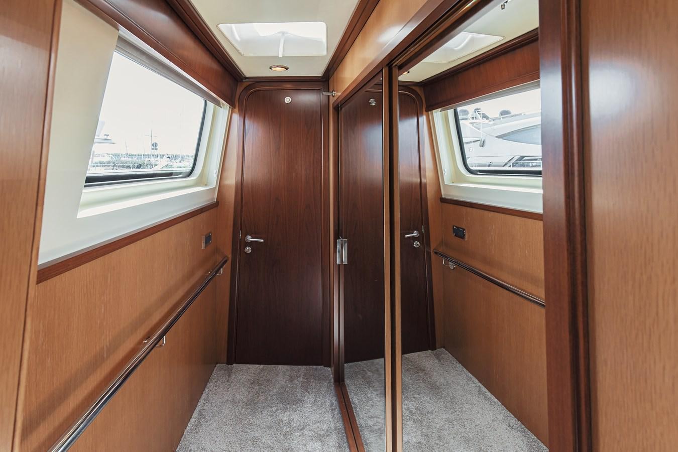 a room with wooden doors aboard XO OF THE SEAS Yacht for Sale