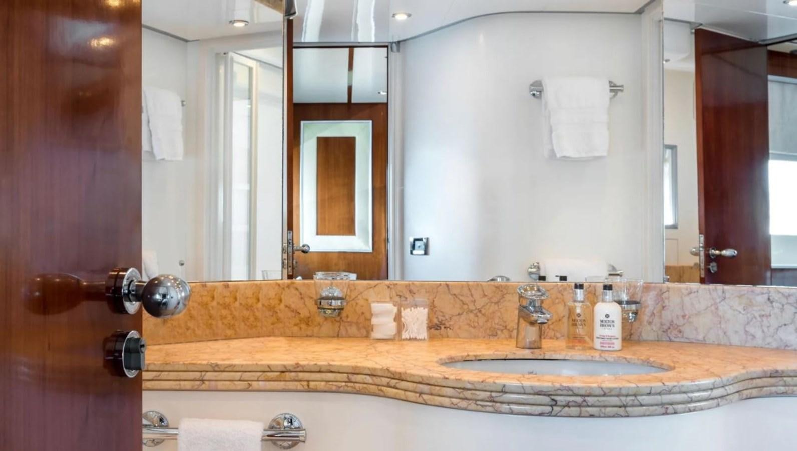 a bathroom with a large mirror aboard NAUGHTY BY NATURE Yacht for Sale
