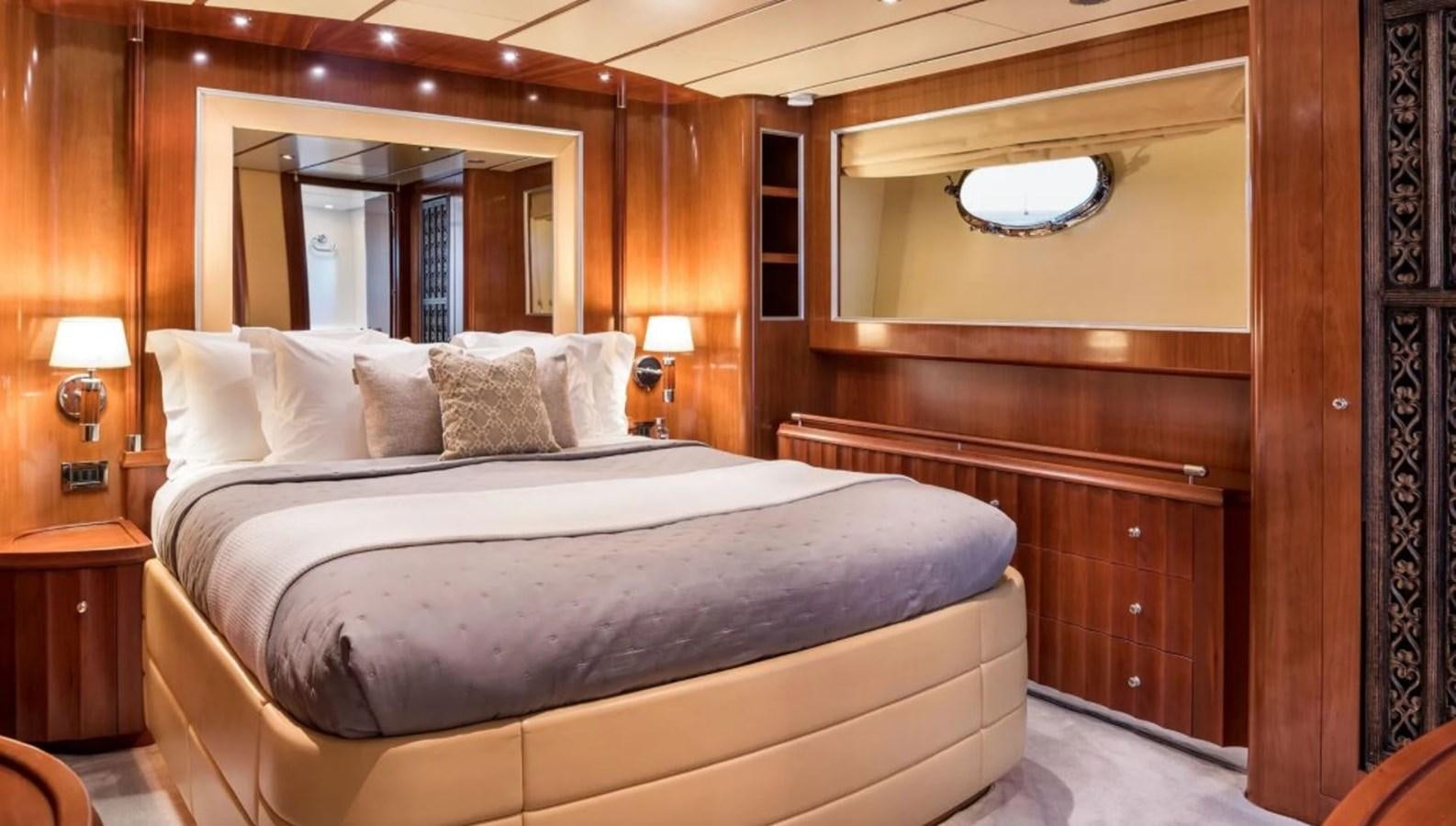 a bed with pillows and a mirror aboard NAUGHTY BY NATURE Yacht for Sale