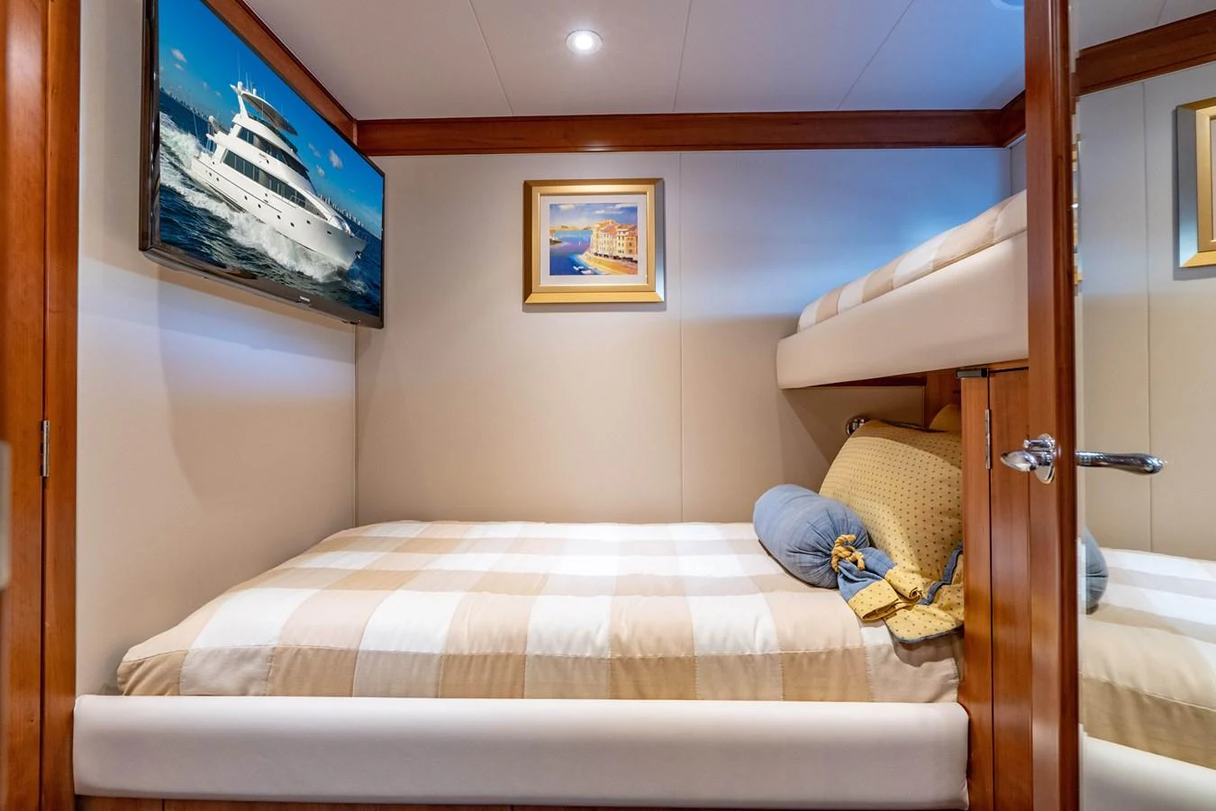 a bed with a pillow and a television on the wall aboard FREE SPIRIT Yacht for Sale