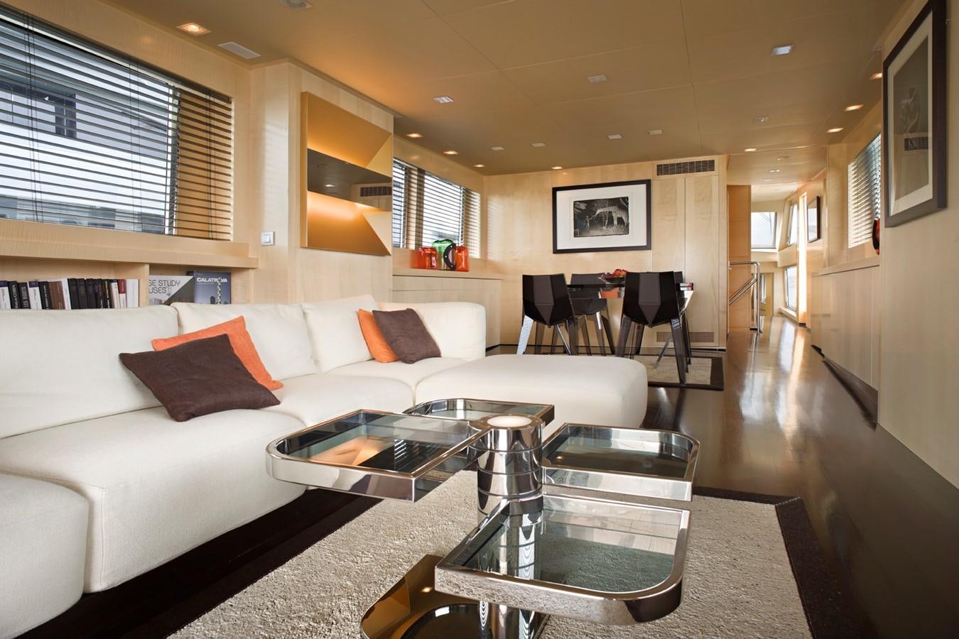 a living room with a white couch and a coffee table aboard TEMPEST WS Yacht for Sale