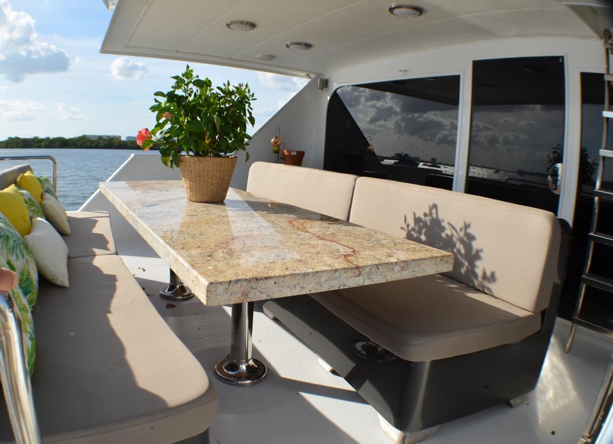 a couch on a patio next to a pool aboard ISABELLA Yacht for Sale