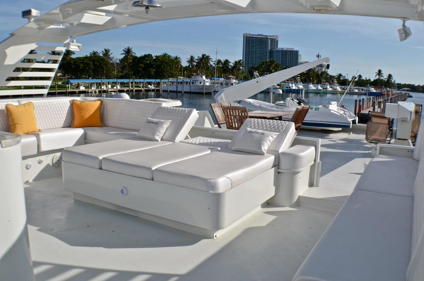 a room with a white couch and a pool with a city in the background aboard ISABELLA Yacht for Sale