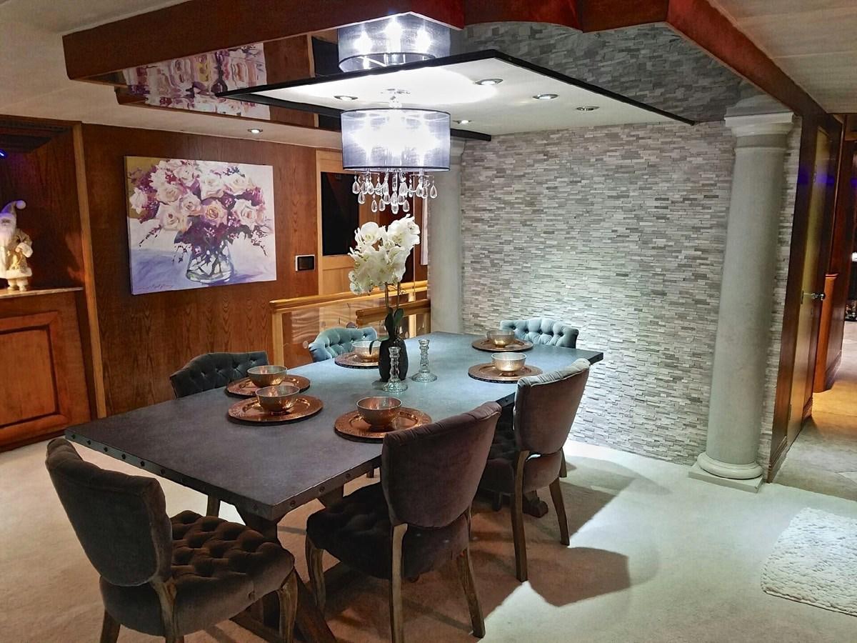 a dining table with chairs aboard ISABELLA Yacht for Sale