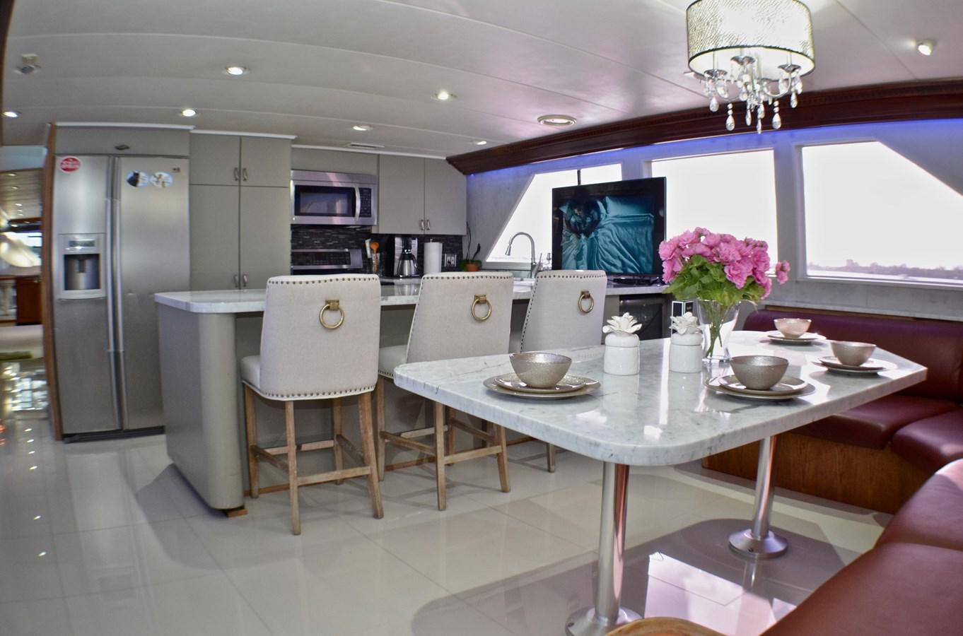 a kitchen with a table and chairs aboard ISABELLA Yacht for Sale