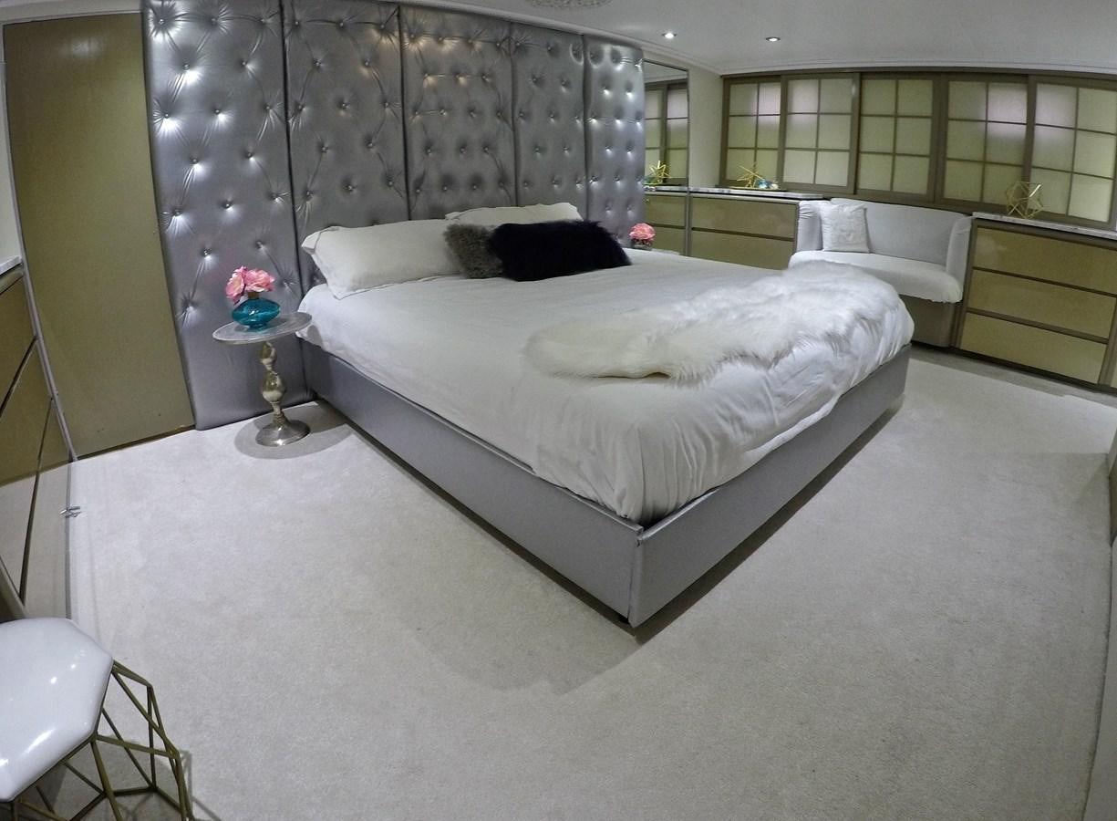 a bedroom with a bed and a window aboard ISABELLA Yacht for Sale