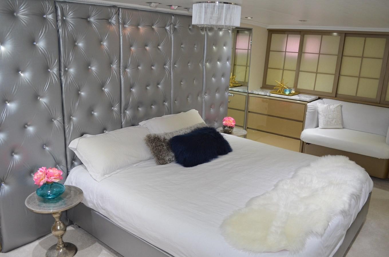 a bed with a white bed spread aboard ISABELLA Yacht for Sale