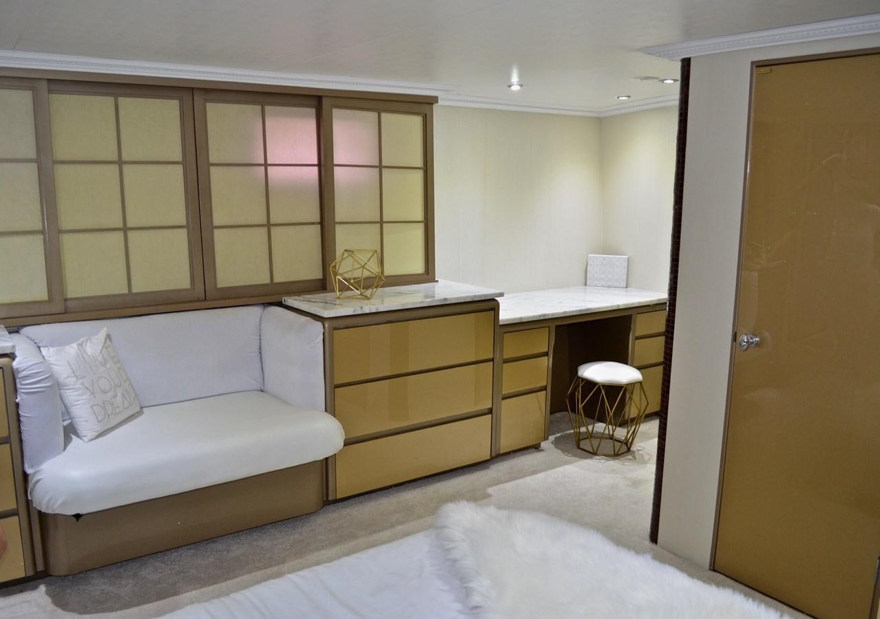 a room with a bed and desk aboard ISABELLA Yacht for Sale