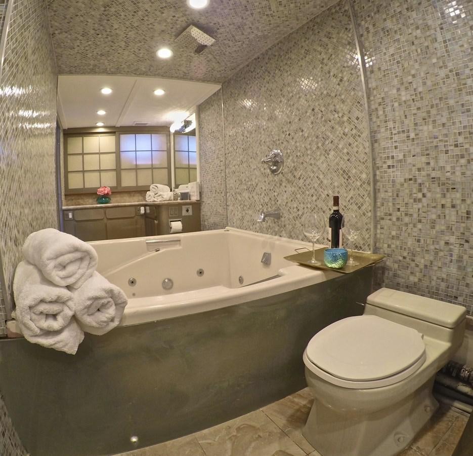 a bathroom with a tub toilet and sink aboard ISABELLA Yacht for Sale