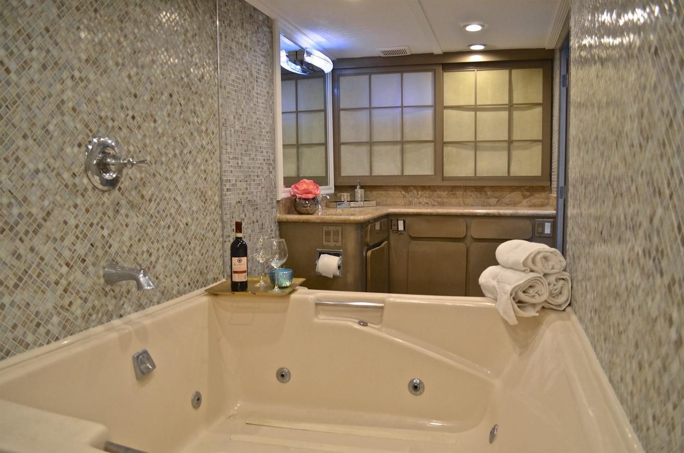 a bathroom with a bathtub and a sink aboard ISABELLA Yacht for Sale