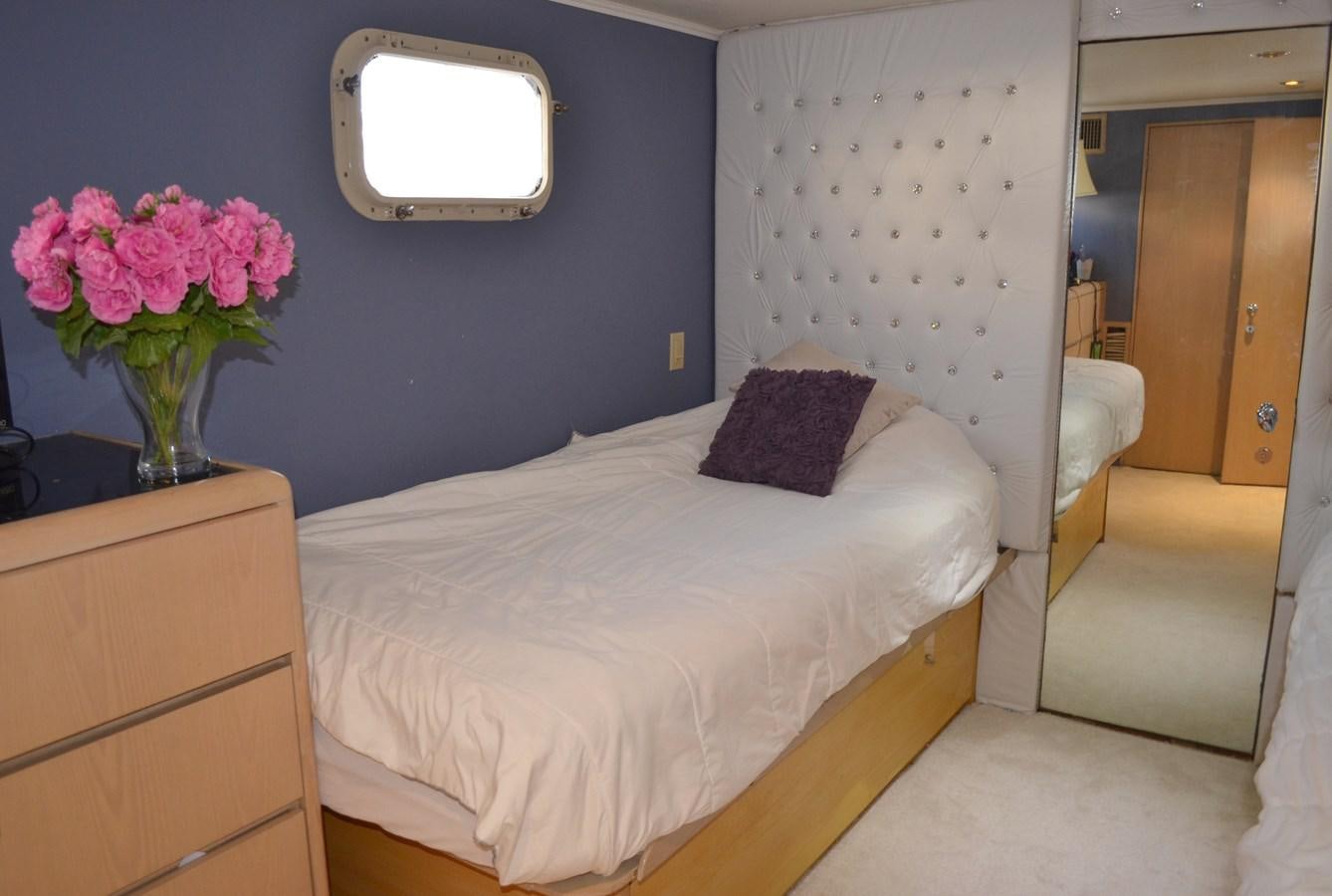 a bedroom with a bed and a mirror aboard ISABELLA Yacht for Sale