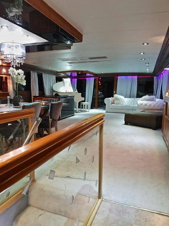 a room with a table and couches aboard ISABELLA Yacht for Sale