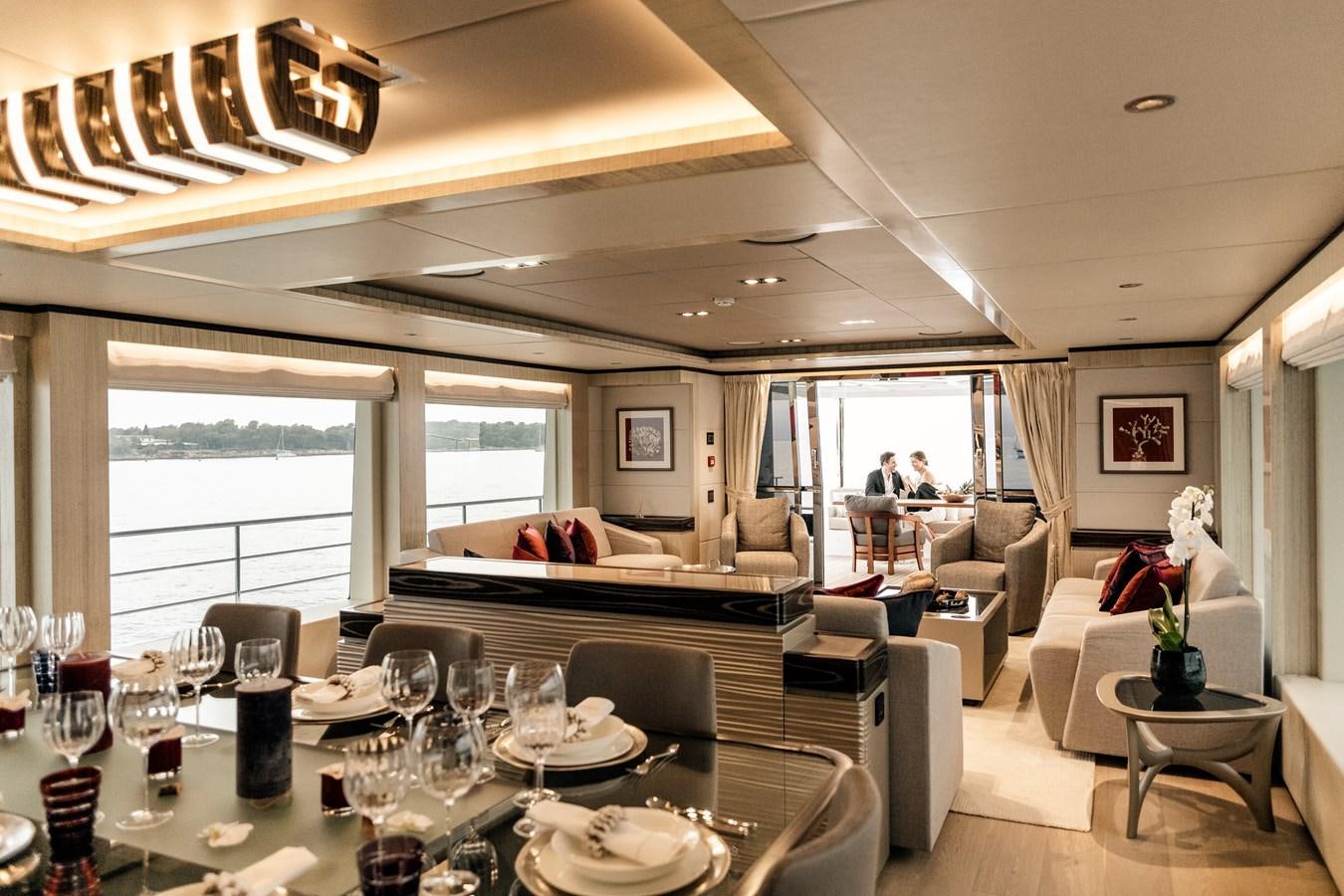 a dining room with a large window aboard LEGACY Yacht for Sale