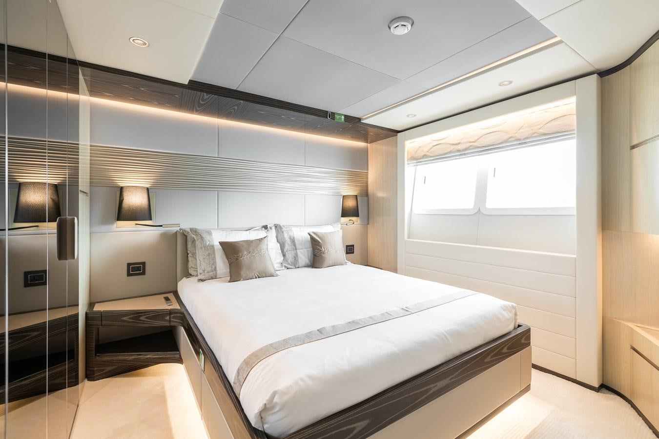 a room with a bed and a window aboard LEGACY Yacht for Sale