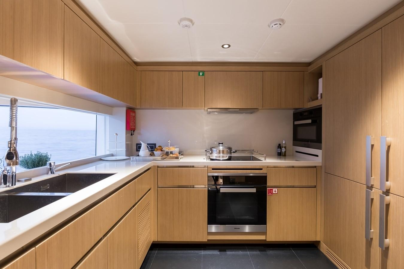 a kitchen with wooden cabinets aboard LEGACY Yacht for Sale
