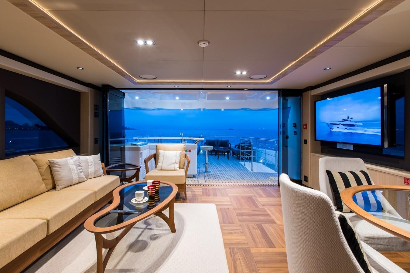 a living room with a large blue ocean aboard LEGACY Yacht for Sale