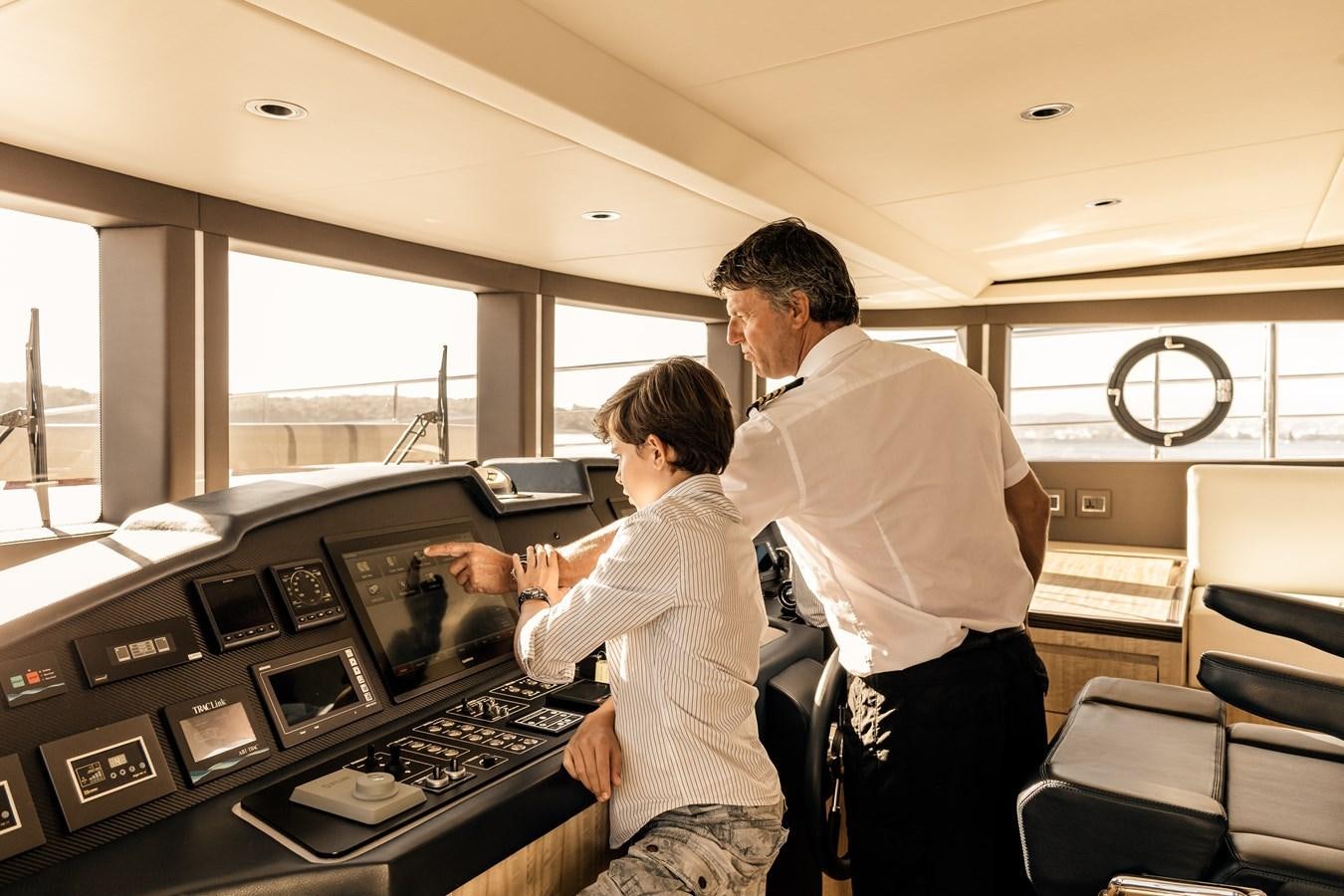a man and a woman in a control room aboard LEGACY Yacht for Sale