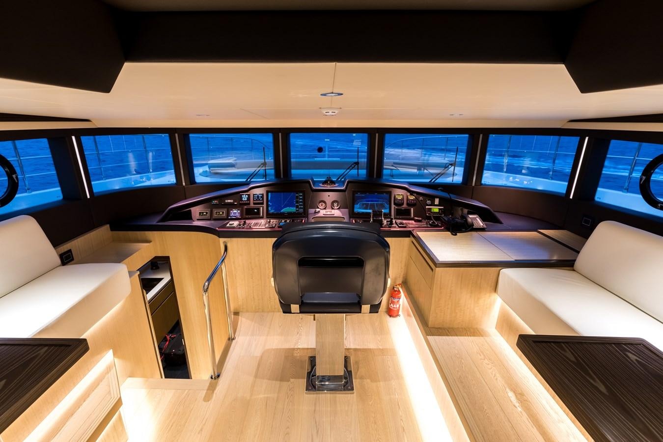 a room with a desk and chairs aboard LEGACY Yacht for Sale