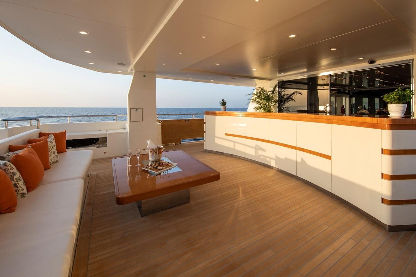 a modern living room with a wood floor and a large window aboard OCEAN DREAM Yacht for Sale