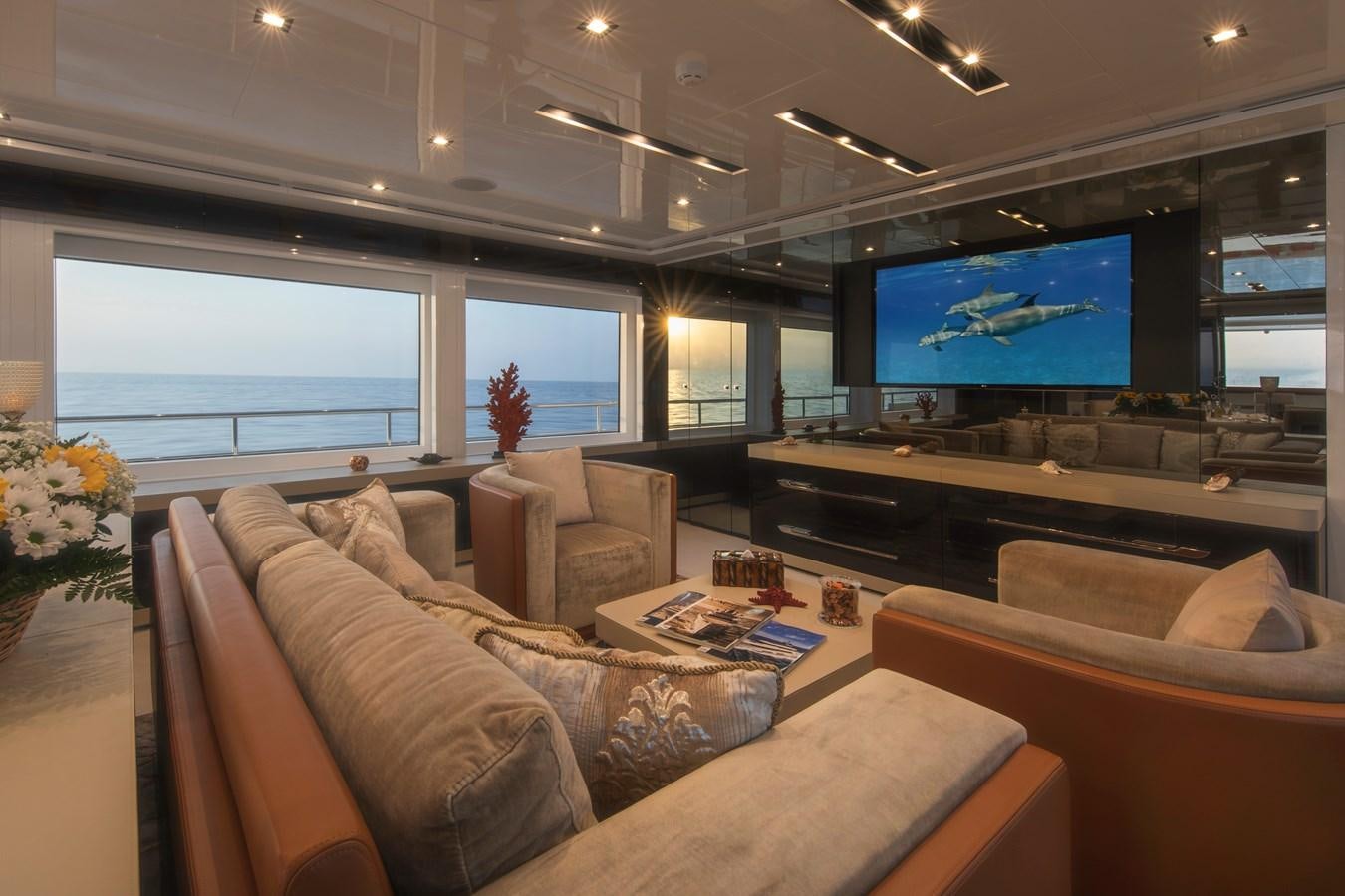 a living room with a large screen aboard OCEAN DREAM Yacht for Sale