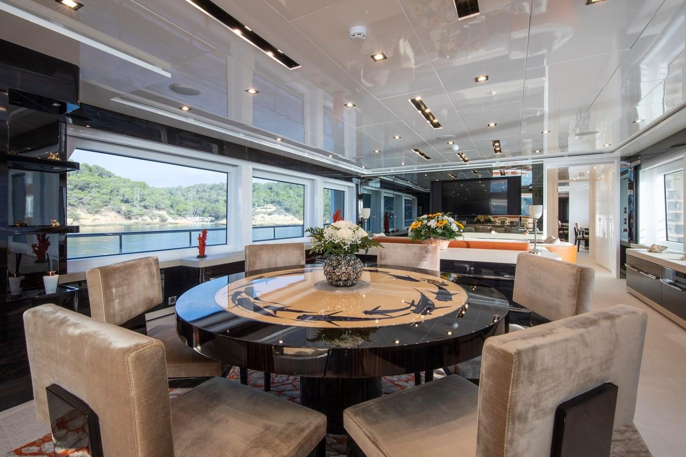 a large room with a table and chairs aboard OCEAN DREAM Yacht for Sale