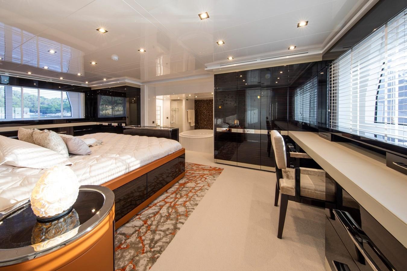 a room with a bed and a desk aboard OCEAN DREAM Yacht for Sale