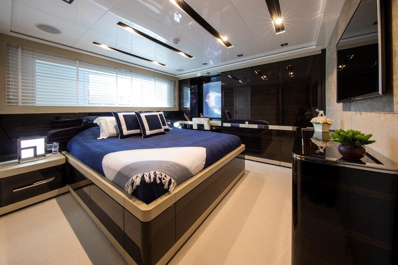 a room with a bed and a desk aboard OCEAN DREAM Yacht for Sale