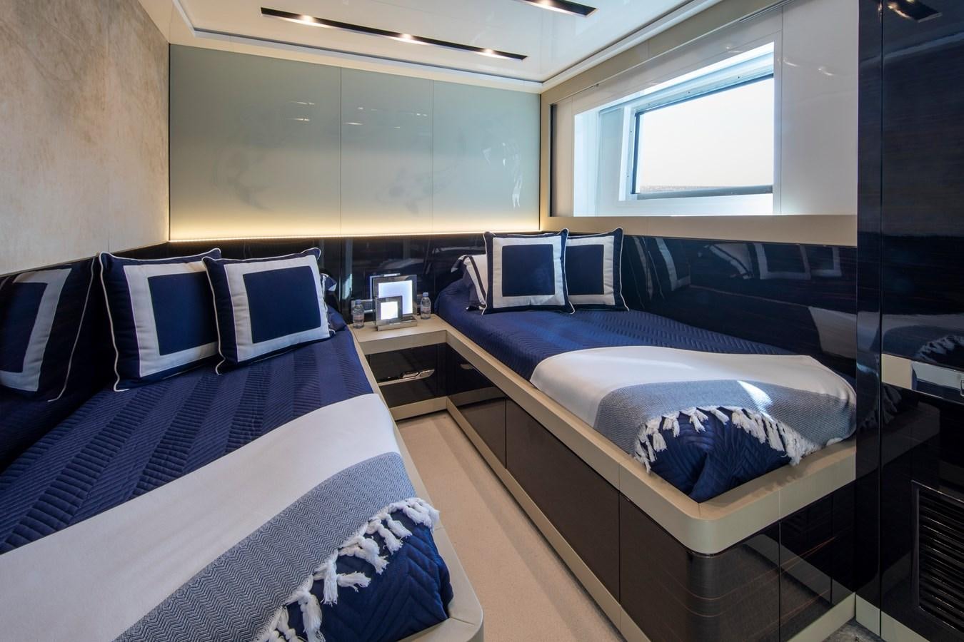 a room with beds and a window aboard OCEAN DREAM Yacht for Sale