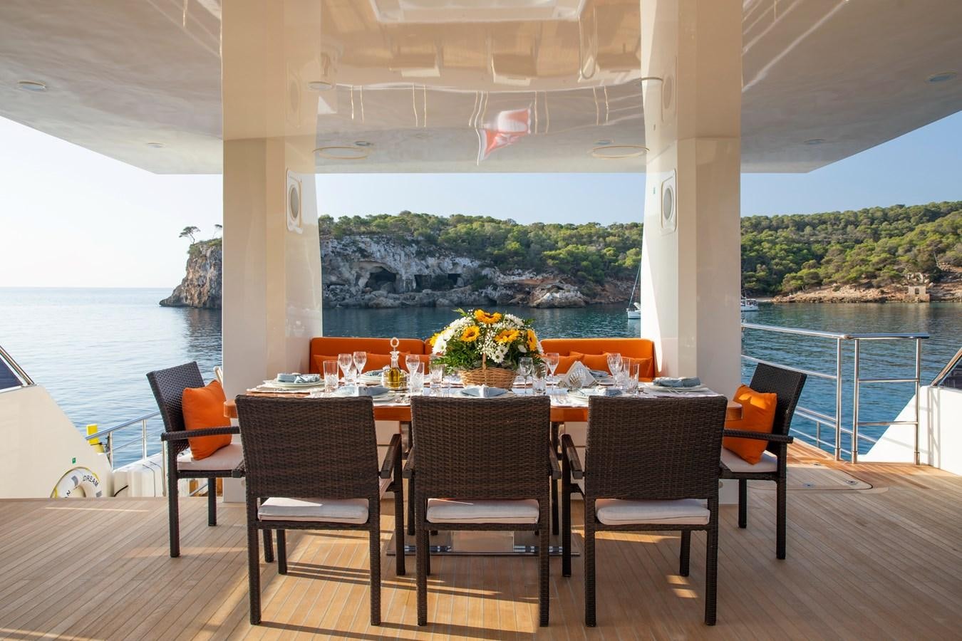 a table and chairs on a deck aboard OCEAN DREAM Yacht for Sale