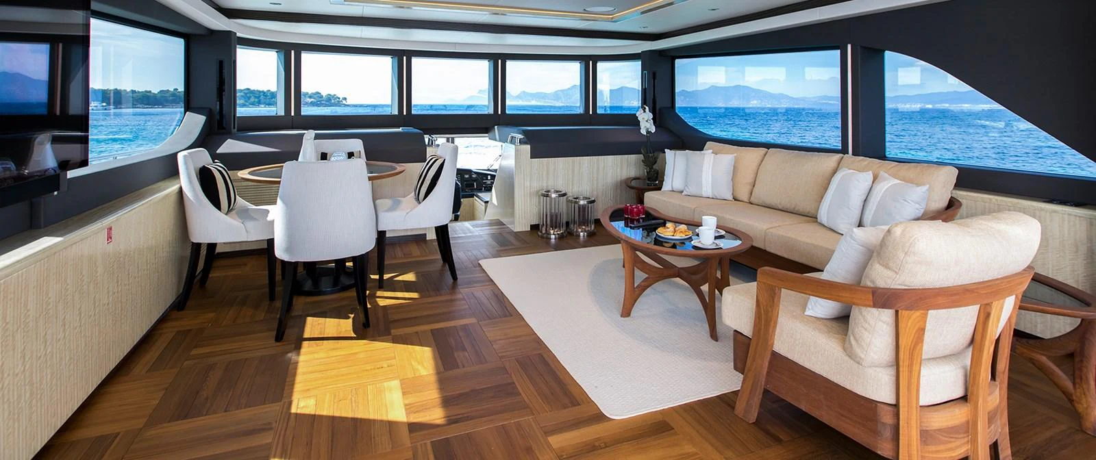 a room with a couch and a table and chairs aboard BARBARA Yacht for Sale