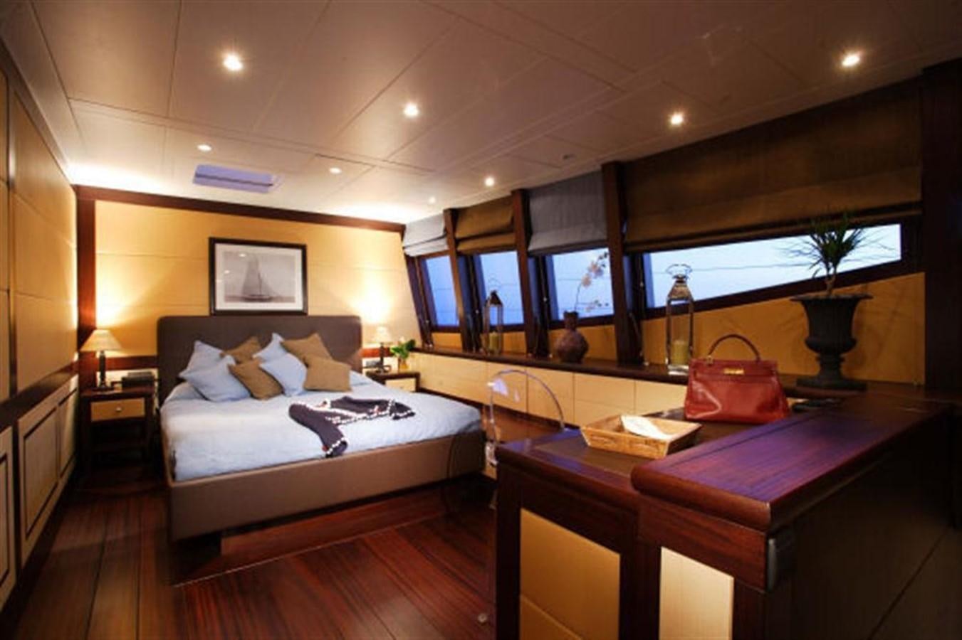 a bedroom with a bed and a desk aboard 102' 2007 BLUBAY 102 Yacht for Sale